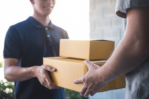 Delivery man handing shipments to customer