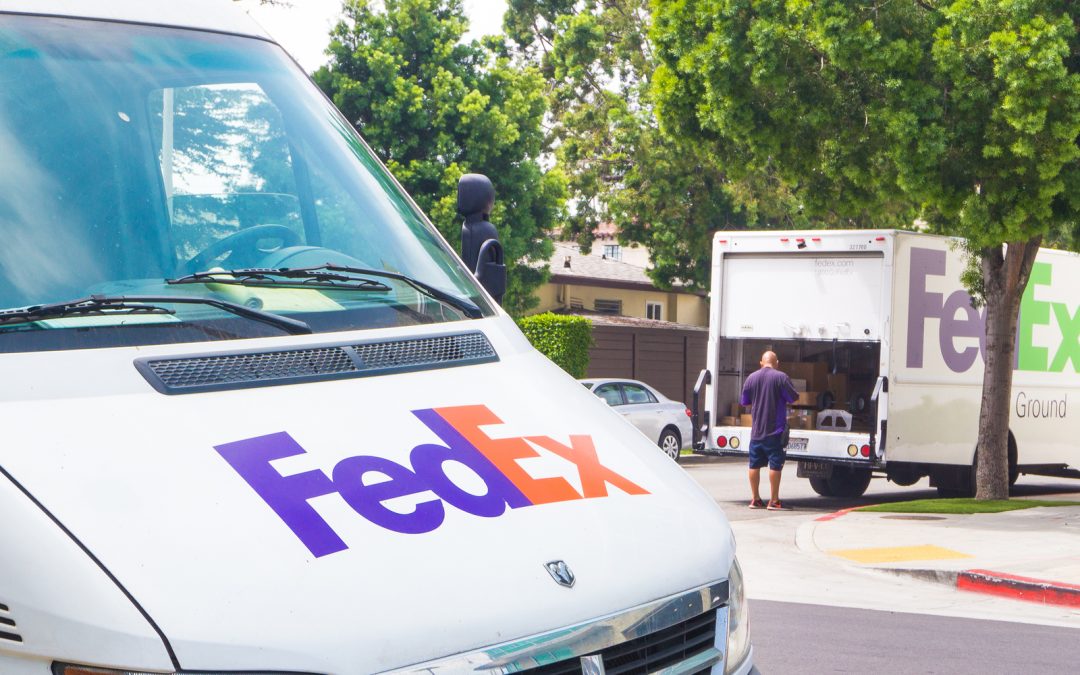 A delivery man dropping off packages on new FedEx delivery days.