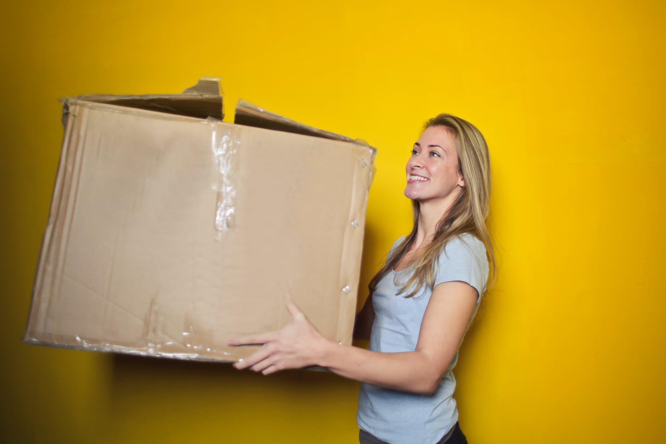 A women holding a box and deciding eCommerce Shipping Integration is Right for her.
